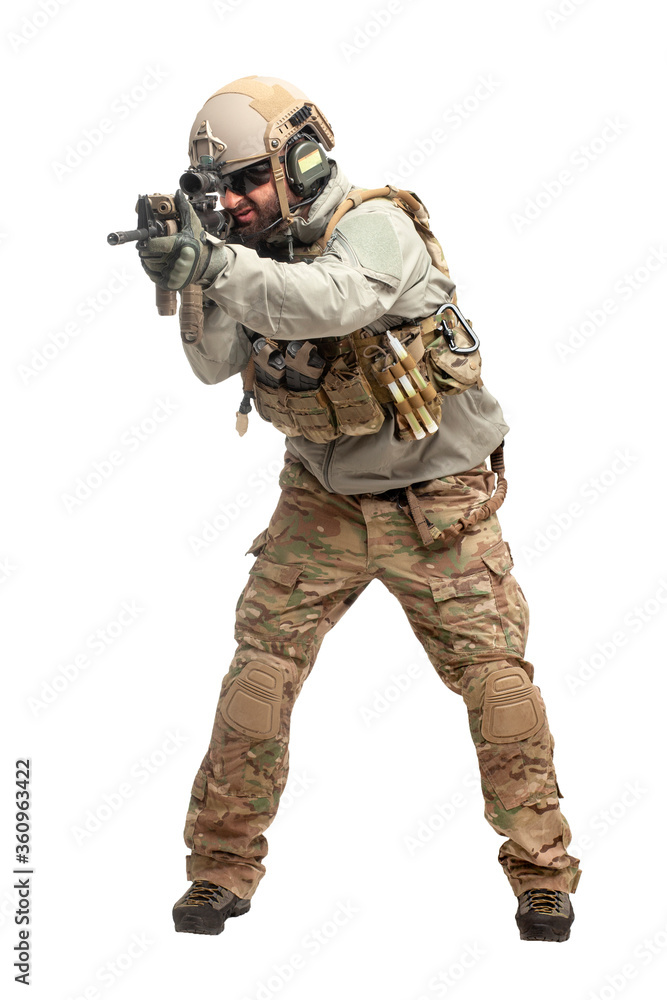 American soldier in uniform and with a rifle aiming and shoots, commando with guns on a white background American soldier in uniform and with a rifle aiming and shoots, commando with guns on a white background