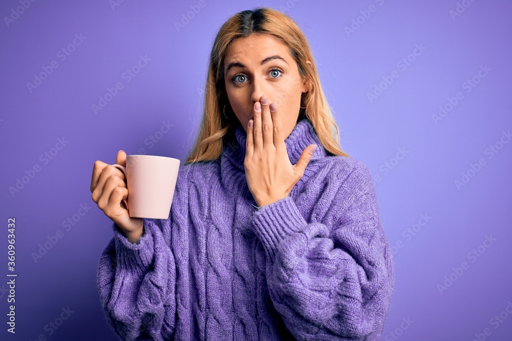 Young beautiful blonde woman drinking cup of coffee over isolated purple background cover mouth with hand shocked with shame for mistake, expression of fear, scared in silence, secret concept Young beautiful blonde woman drinking cup of coffee over isolated purple background cover mouth with hand shocked with shame for mistake, expression of fear, scared in silence, secret concept