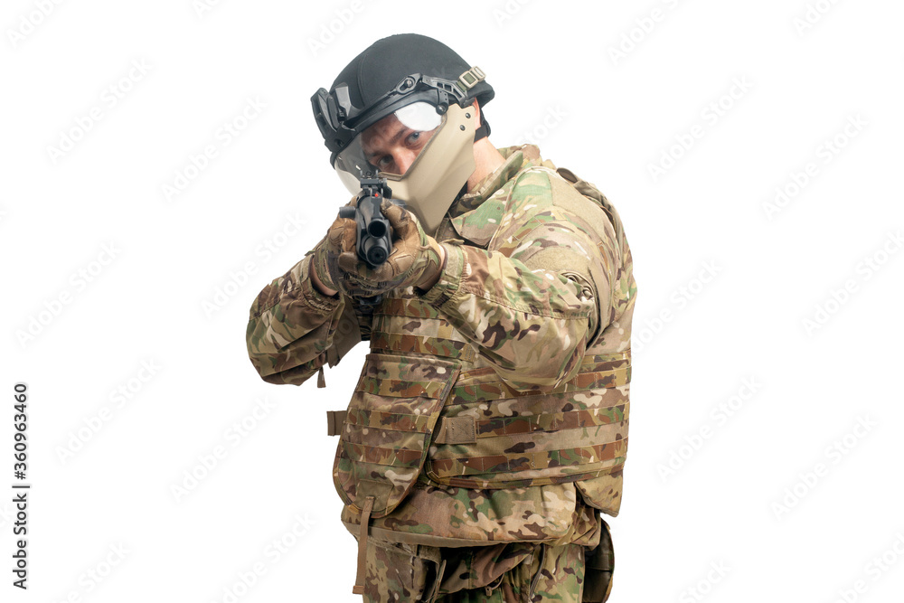 Fototapeta premium soldier in military equipment with a shotgun to aim and attack on a white background, a special forces officer storms