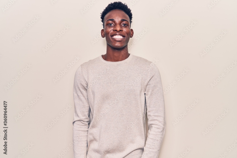 Young african american man wearing casual clothes with a happy and cool smile on face. lucky person. Young african american man wearing casual clothes with a happy and cool smile on face. lucky person.