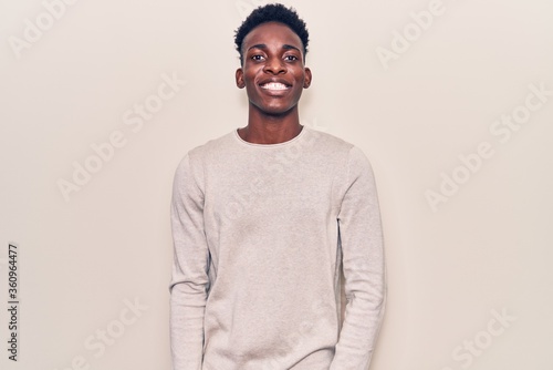 Young african american man wearing casual clothes with a happy and cool smile on face. lucky person.