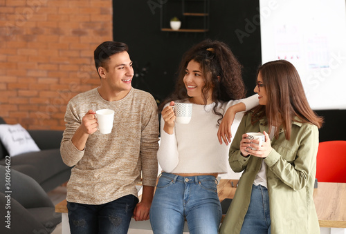 Young business people drinking coffee in office