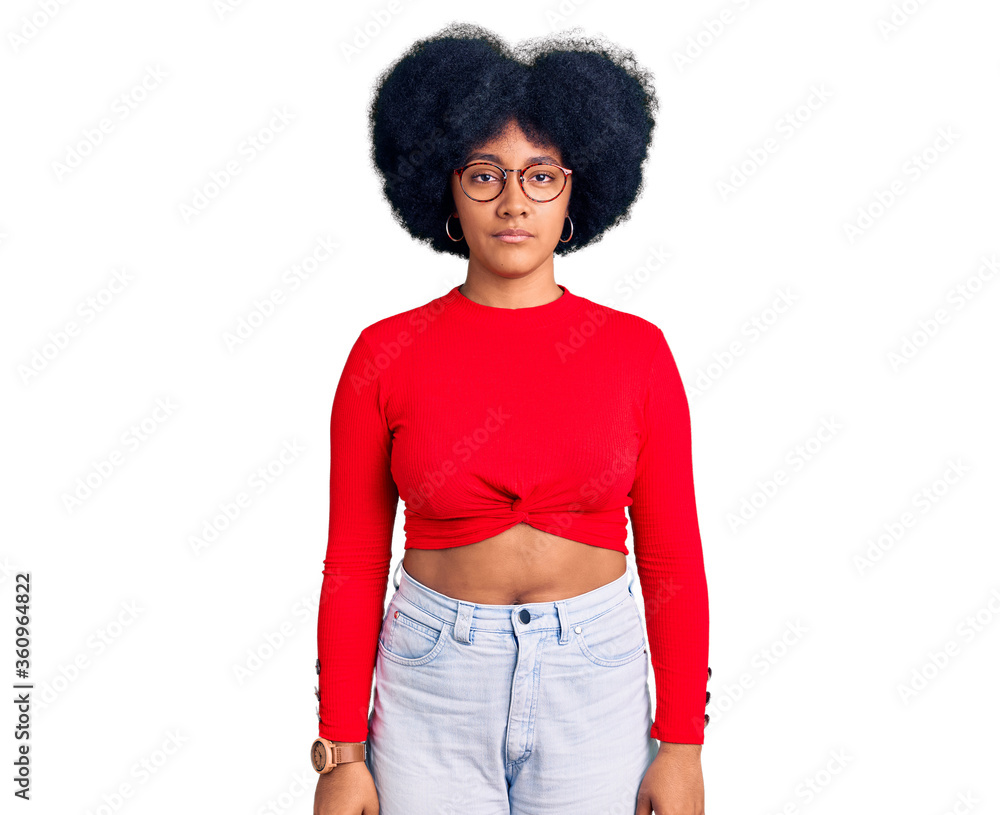 Young african american girl wearing casual clothes and glasses relaxed with serious expression on face. simple and natural looking at the camera. Young african american girl wearing casual clothes and glasses relaxed with serious expression on face. simple and natural looking at the camera.