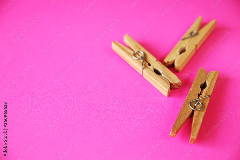wooden clothes pins on pink background wooden clothes pins on pink background