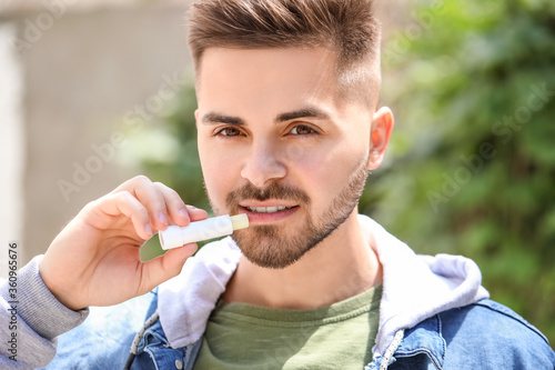 Handsome young man with lip...