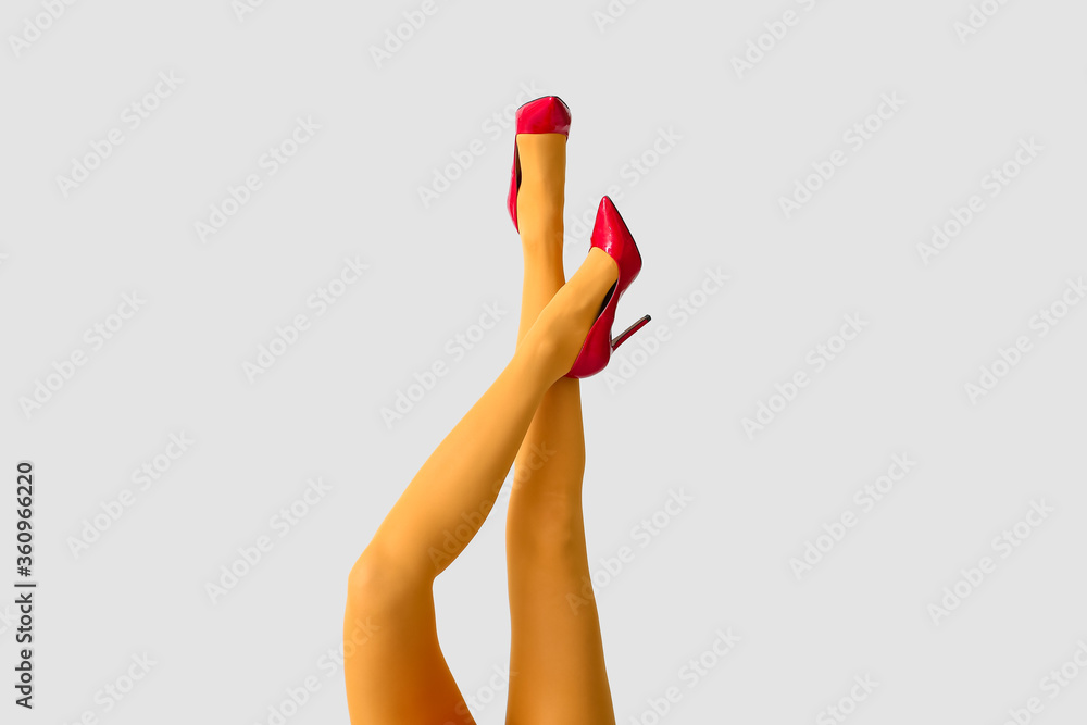 Beautiful young woman in tights on light background Beautiful young woman in tights on light background