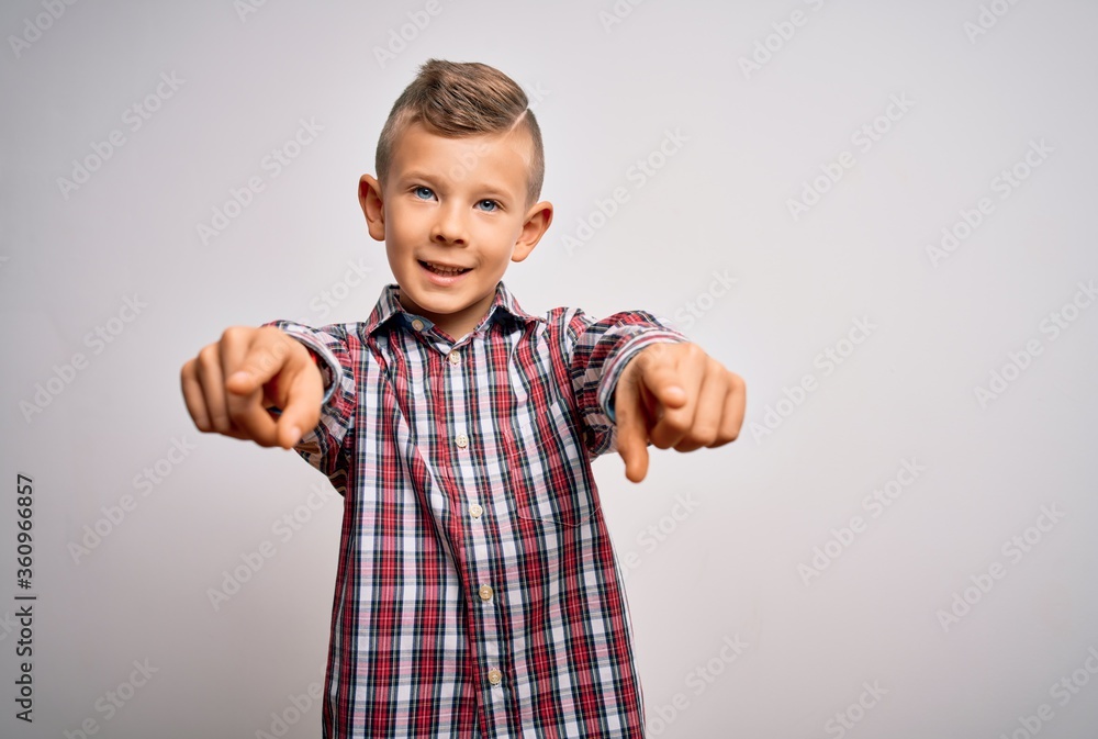 Young little caucasian kid with blue eyes wearing elegant shirt standing over isolated background pointing to you and the camera with fingers, smiling positive and cheerful Young little caucasian kid with blue eyes wearing elegant shirt standing over isolated background pointing to you and the camera with fingers, smiling positive and cheerful