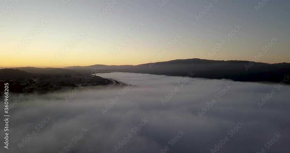 Misty mountain Valley filled with fog clouds during sunrise with golden gradient sky camera turning right Misty mountain Valley filled with fog clouds during sunrise with golden gradient sky camera turning right