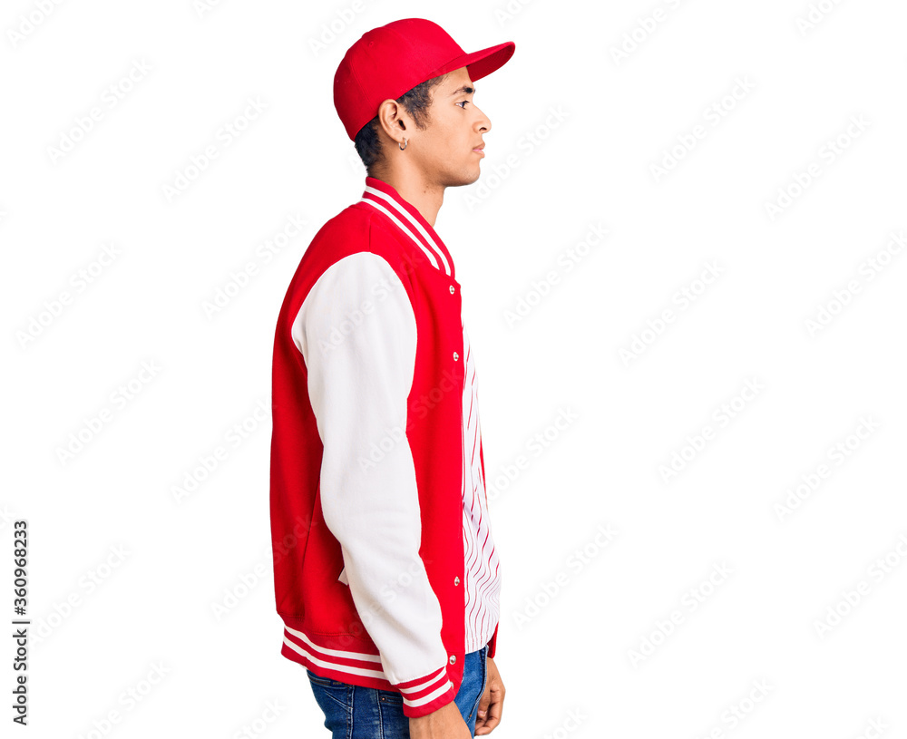 Young african amercian man wearing baseball uniform looking to side, relax profile pose with natural face with confident smile. Young african amercian man wearing baseball uniform looking to side, relax profile pose with natural face with confident smile.