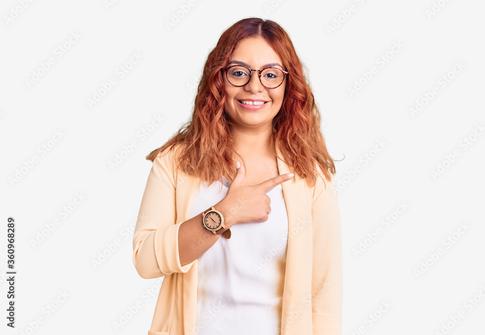 Young latin woman wearing business clothes cheerful with a smile of face pointing with hand and finger up to the side with happy and natural expression on face Young latin woman wearing business clothes cheerful with a smile of face pointing with hand and finger up to the side with happy and natural expression on face