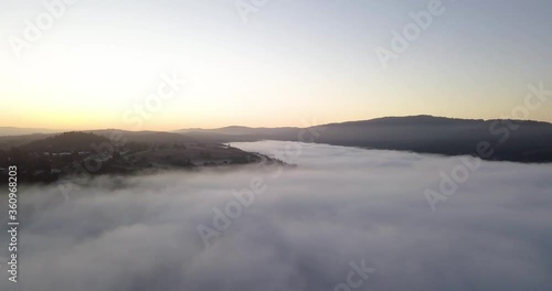 Wallpaper Mural Misty mountain Valley filled with fog clouds during sunrise with golden gradient sky camera turning left fast Torontodigital.ca