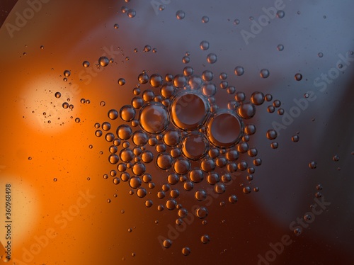 Closeup orange bubbles oil with soft focus and blurred background ,macro image ,abstract background ,water droplets, soap bubbles ,sweet color for card design water drops on glass