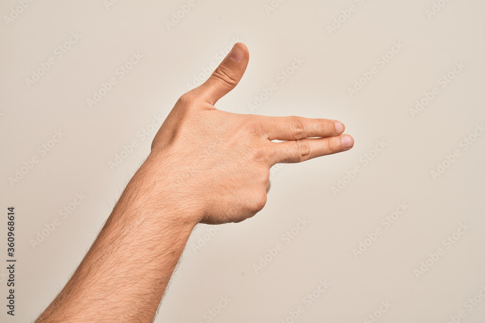 Hand of caucasian young man showing fingers over isolated white background gesturing fire gun weapon with fingers, aiming shoot symbol Hand of caucasian young man showing fingers over isolated white background gesturing fire gun weapon with fingers, aiming shoot symbol