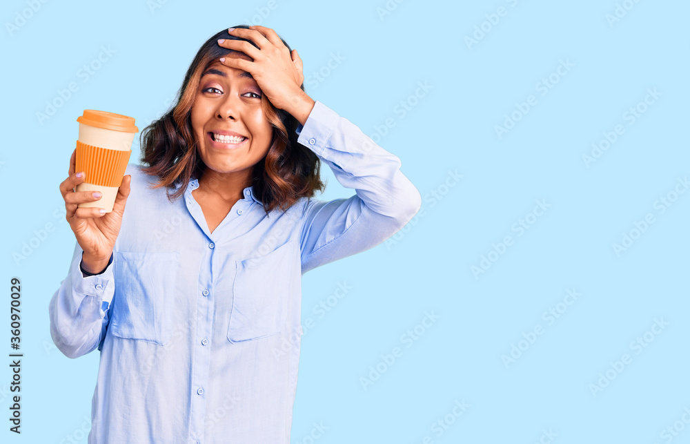 Young beautiful mixed race woman drinking a coffee from take away cup stressed and frustrated with hand on head, surprised and angry face Young beautiful mixed race woman drinking a coffee from take away cup stressed and frustrated with hand on head, surprised and angry face