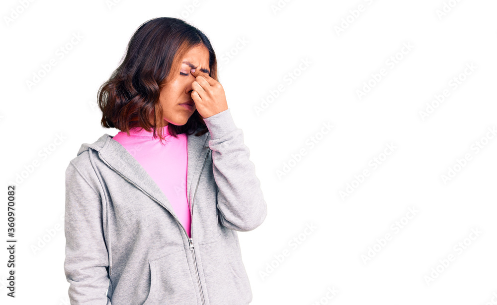 Young beautiful mixed race woman wearing casual sporty clothes tired rubbing nose and eyes feeling fatigue and headache. stress and frustration concept. Young beautiful mixed race woman wearing casual sporty clothes tired rubbing nose and eyes feeling fatigue and headache. stress and frustration concept.