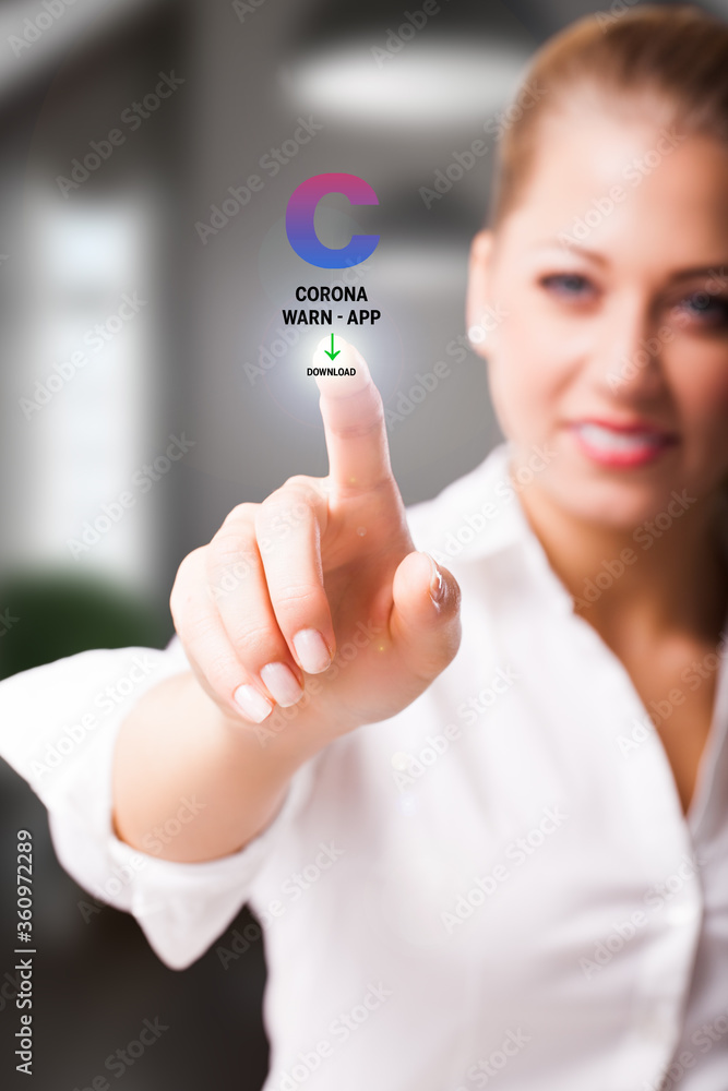 Obraz premium woman is touching a virtual button to download the CORONA WARN APP