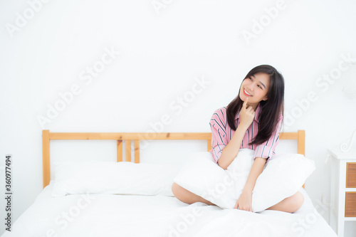 Beautiful young asian woman think idea, planning with inspiration on bed in bedroom at home, girl thought future and dream, expression of positive, female with healthy wake up and relax at room.