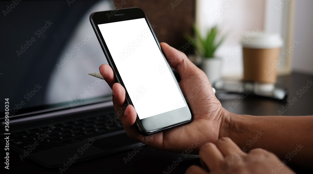 Mock up smartphone of hand holding black mobile phone with blank white screen. Mock up smartphone of hand holding black mobile phone with blank white screen.