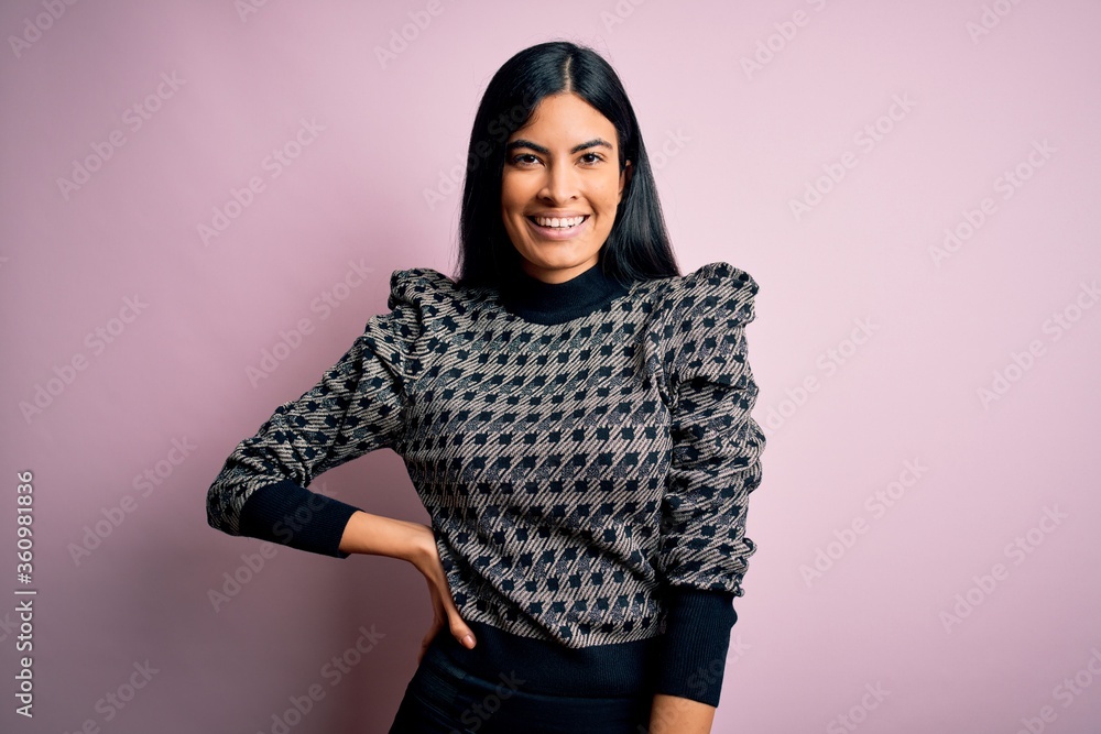 Young beautiful woman wearing fashion urban clothes, model wearing casual street style standing over pink background