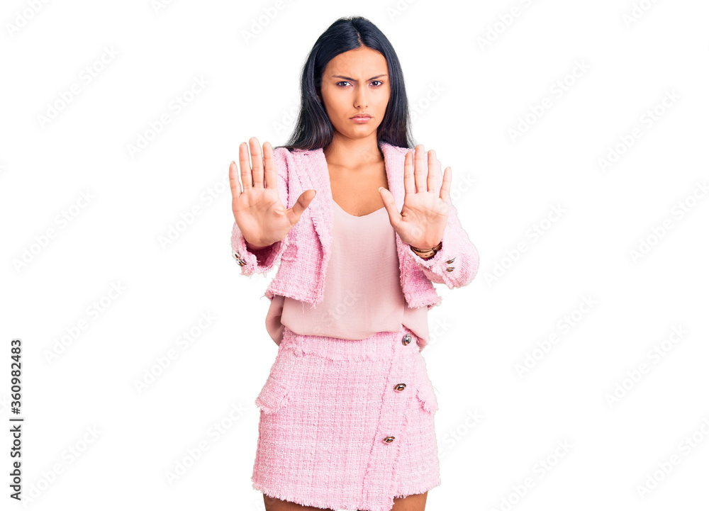 Young beautiful latin girl wearing business clothes moving away hands palms showing refusal and denial with afraid and disgusting expression. stop and forbidden. Young beautiful latin girl wearing business clothes moving away hands palms showing refusal and denial with afraid and disgusting expression. stop and forbidden.