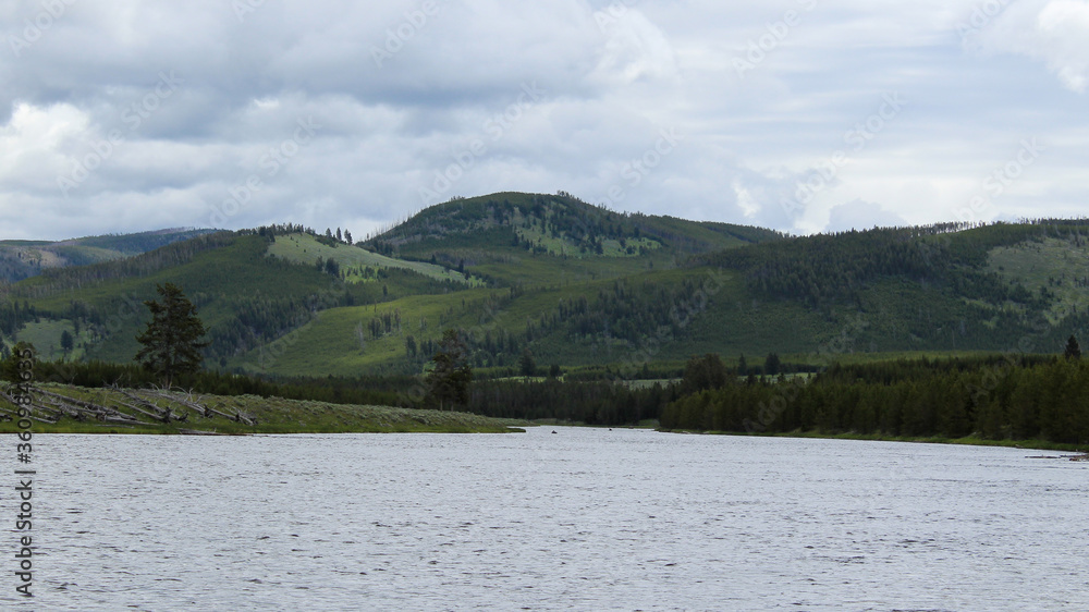 Landscape scene of river and rolling hills Landscape scene of river and rolling hills