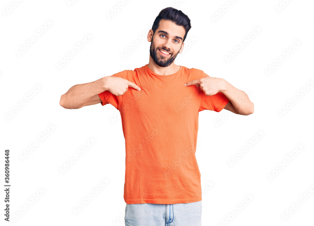 Young handsome man with beard wearing casual t-shirt looking confident with smile on face, pointing oneself with fingers proud and happy. Young handsome man with beard wearing casual t-shirt looking confident with smile on face, pointing oneself with fingers proud and happy.
