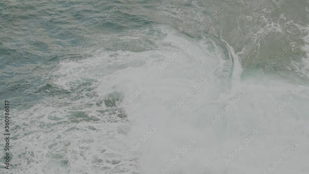 slow motion huge powerful waves crashing over submerged rocks slow motion huge powerful waves crashing over submerged rocks