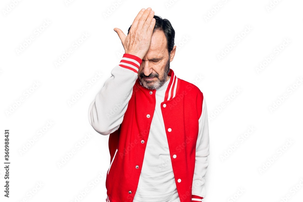 Middle age handsome man wearing baseball jacket over isolated white background surprised with hand on head for mistake, remember error. Forgot, bad memory concept. Middle age handsome man wearing baseball jacket over isolated white background surprised with hand on head for mistake, remember error. Forgot, bad memory concept.