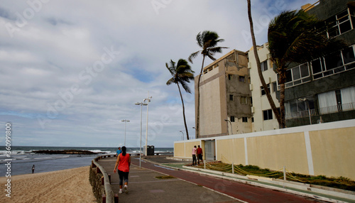 salvador, bahia / brazil - july 29, 2016: people are seen walking on a sidewalk near Amaralina beach in the city of Salvador.

 photo