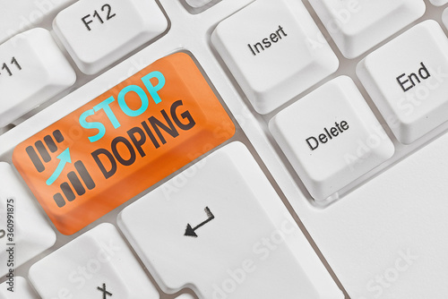 Handwriting text Stop Doping. Conceptual photo quit the use of banned athletic performanceenhancing drugs White pc keyboard with empty note paper above white key copy space photo