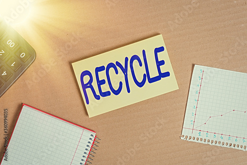 Word writing text Recycle. Business photo showcasing process of converting waste materials into new materials and objects Cardboard paperboard notebook office study supplies chart reminder paper photo