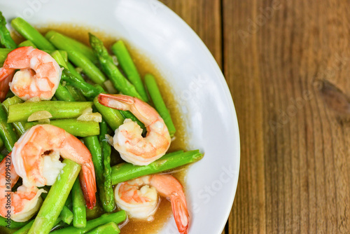 Asparagus Shrimp Seafood Cooked Health Food - Stir fried shrimps with asparagus green on white plate and wooden table background