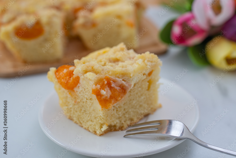 home made german apricot streusel cake on a table home made german apricot streusel cake on a table