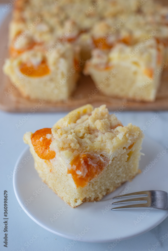 home made german apricot streusel cake on a table home made german apricot streusel cake on a table