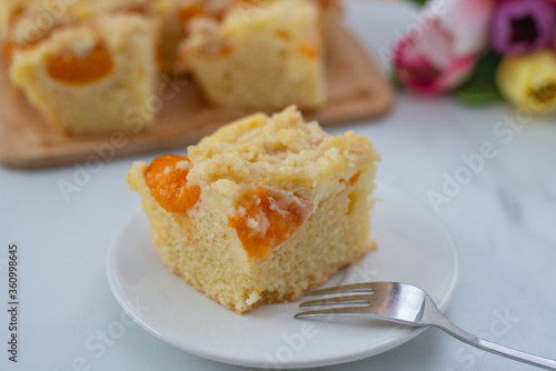 home made german apricot streusel cake on a table