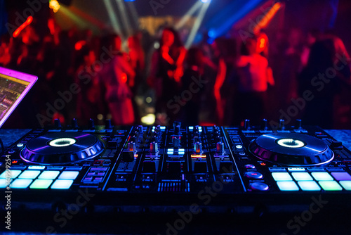 music controller DJ mixer in a nightclub at a party photo