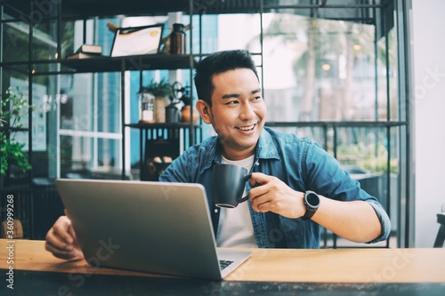 Smart Asian man working with laptop laptop.