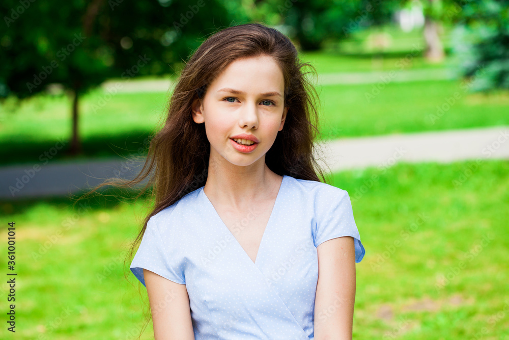 Portrait of a young beautiful brunette girl in summer park Portrait of a young beautiful brunette girl in summer park