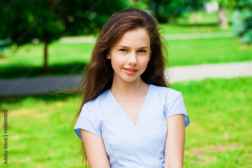 Portrait of a young beautiful brunette girl in summer park Portrait of a young beautiful brunette girl in summer park