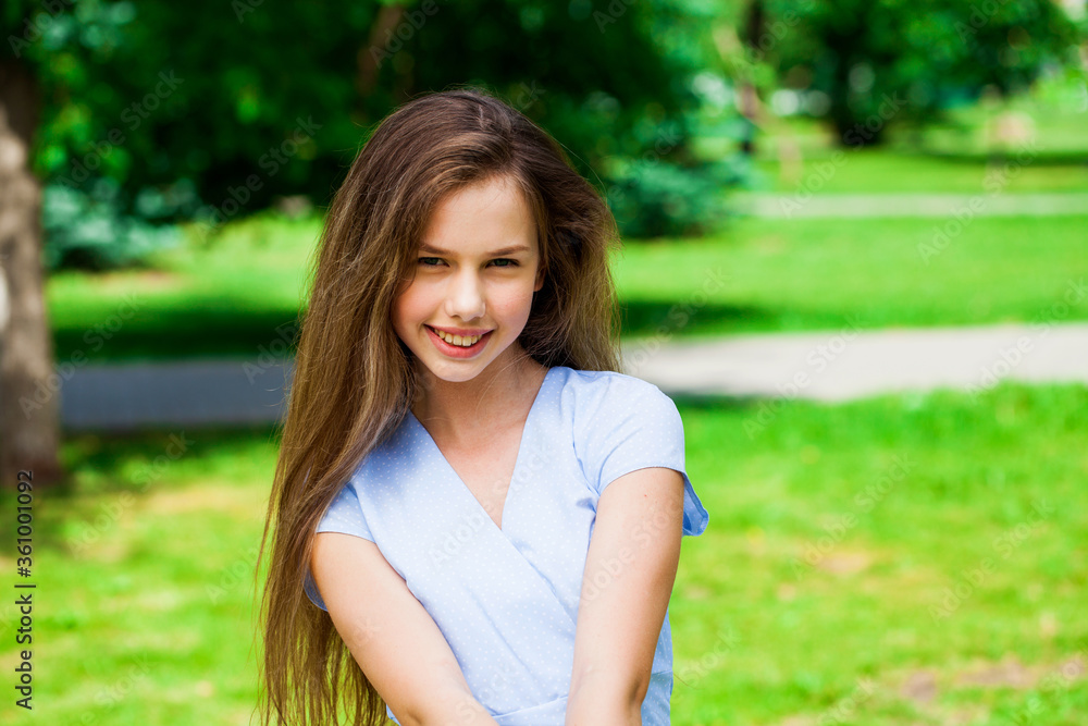 Portrait of a young beautiful brunette girl in summer park Portrait of a young beautiful brunette girl in summer park
