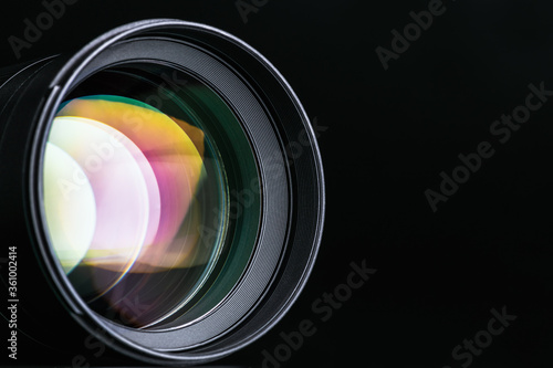 The camera lens. Close-up of the camera lens on a black background. Optics.