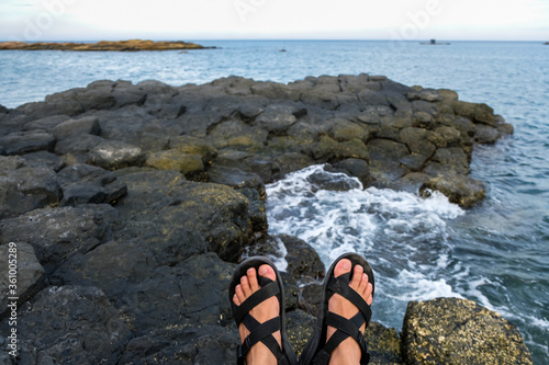 a man standing on The Sea Cliff of Stone Plates in Phu Yen, Vietnam.