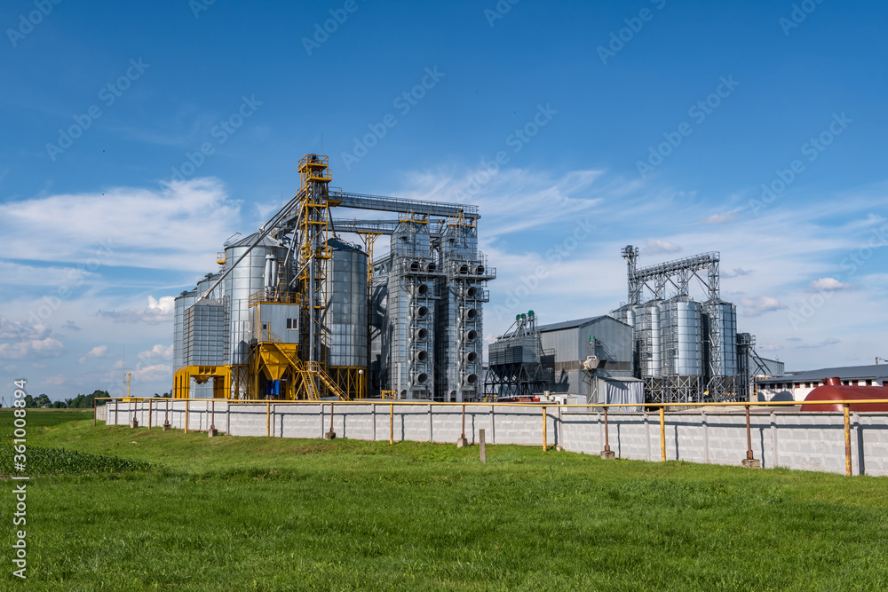 silver silos on agro-processing and manufacturing plant for processing drying cleaning and storage of agricultural products, flour, cereals and grain. Granary elevator. silver silos on agro-processing and manufacturing plant for processing drying cleaning and storage of agricultural products, flour, cereals and grain. Granary elevator.