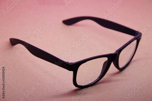 black eye glasses isolated on pink background