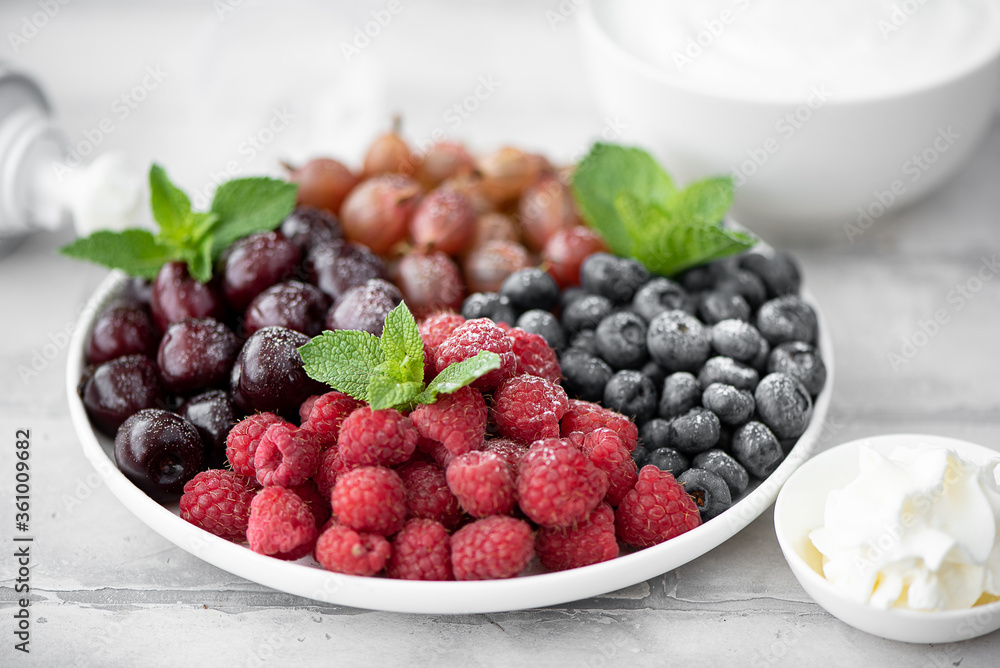 mix of fresh summer berries with yogurt and whipped cream mix of fresh summer berries with yogurt and whipped cream