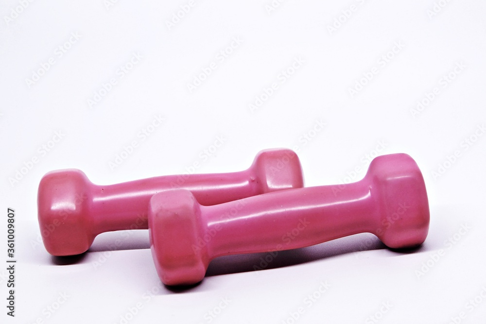 Two pink dumbbells isolated on white background
Two pink dumbbells isolated on white background