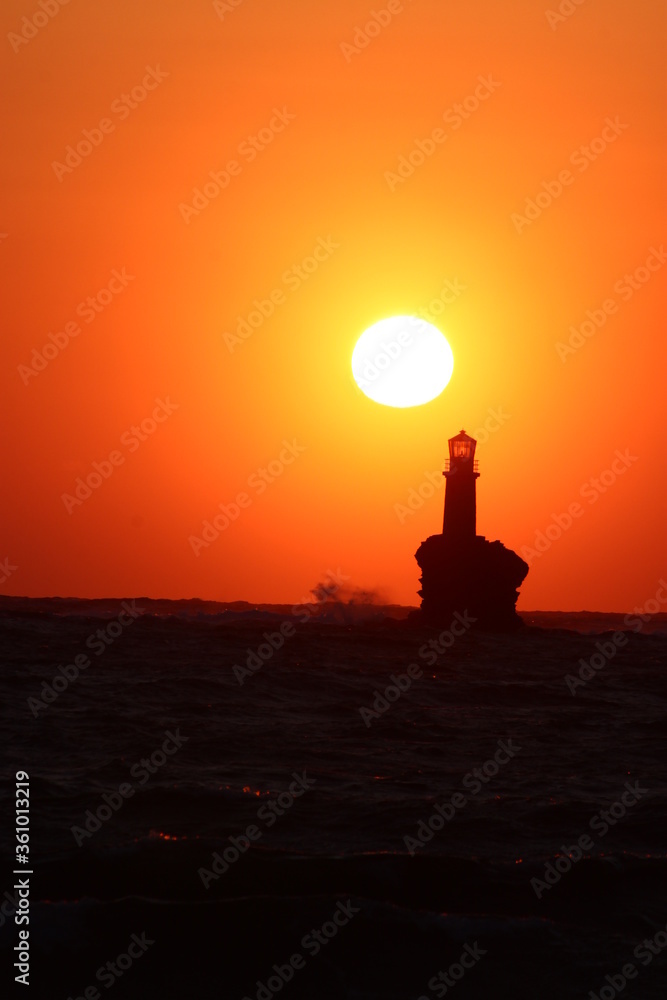Sunrise at the lighthouse of Tourlitis at Andros, Greece Sunrise at the lighthouse of Tourlitis at Andros, Greece