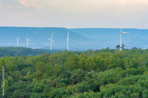Wind turbine renewable energy source summer in forest mountains landscape energy transmission distribution equipment in natural environment