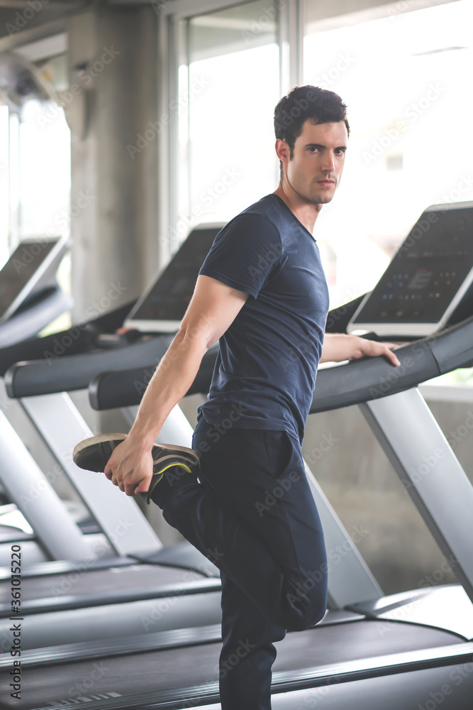 Handsome man warm up before exercise workout in gym fitness breaking relax for running on treadmill in fitness gym at sport club