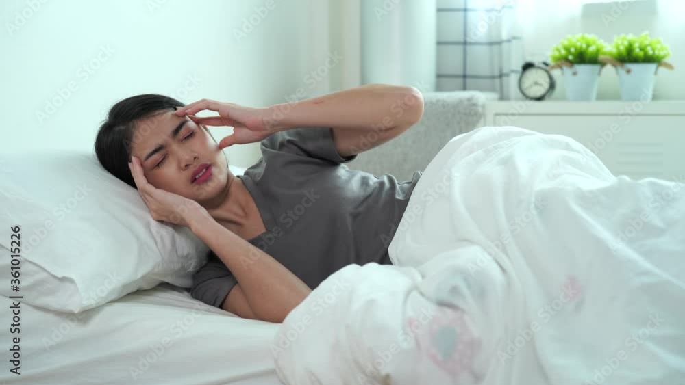 Asian woman in bed, She has dizziness, Migraine. Asian woman in bed, She has dizziness, Migraine.